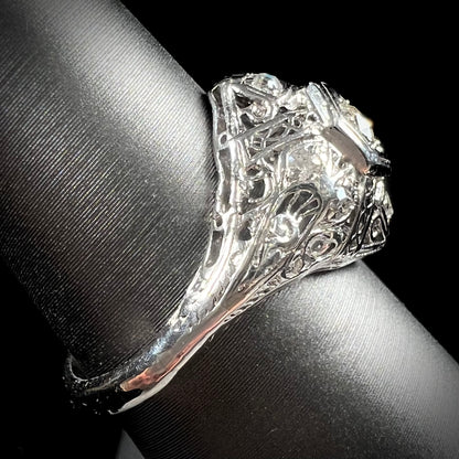 An antique ladies' platinum diamond filigree engagement ring.  The center stone is an old European cut diamond.