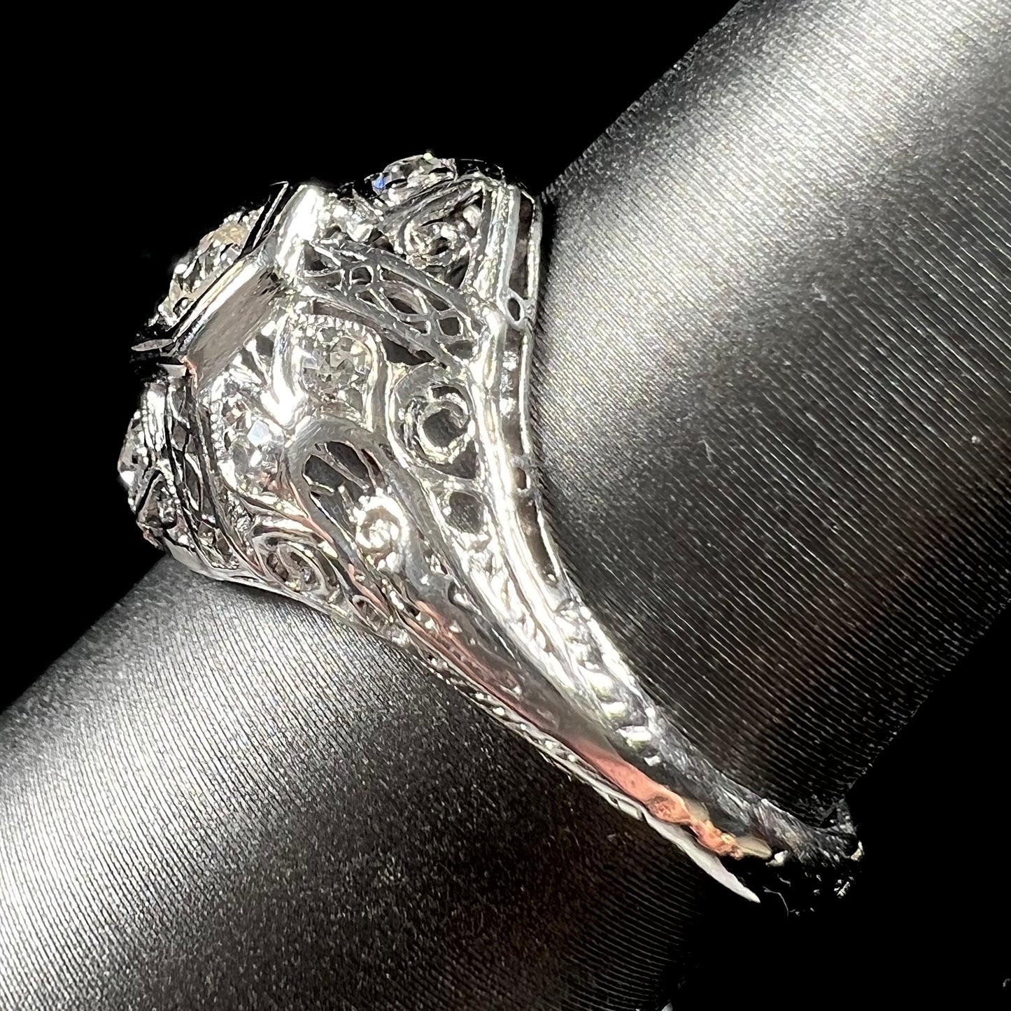 An antique ladies' platinum diamond filigree engagement ring.  The center stone is an old European cut diamond.