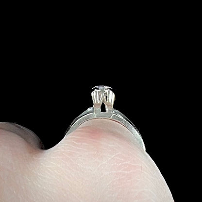 A ladies' vintage 14kt white gold 1940's diamond solitaire ring.  The diamond is chipped in two places.