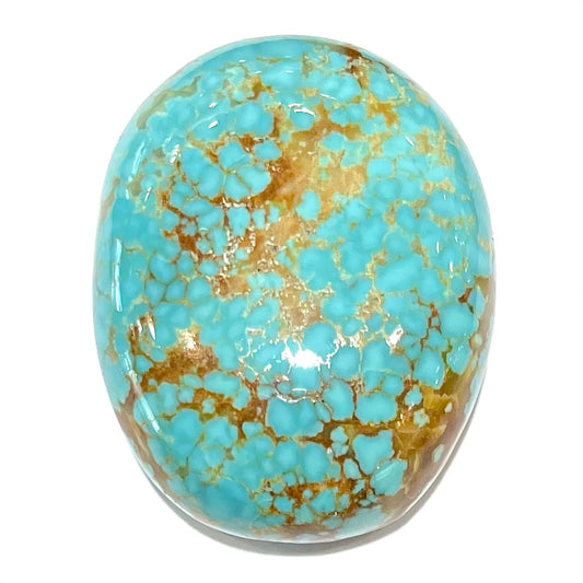 A loose, oval cut turquoise cabochon from Number 8 Mine, Nevada.  The stone is blue with a golden brown webbed matrix.