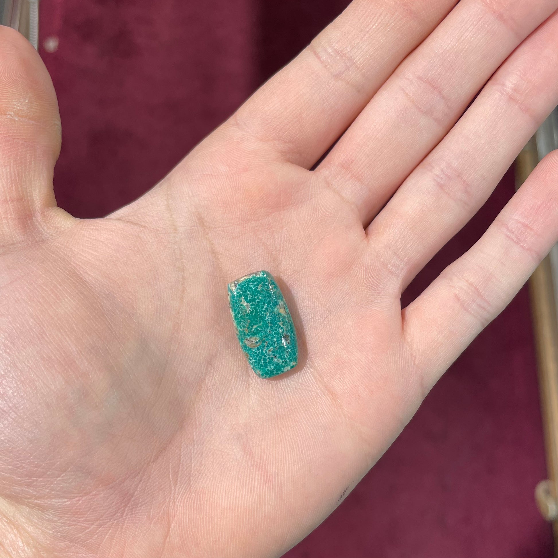 A loose, green cabochon cut turquoise stone from Royston District, Nevada.