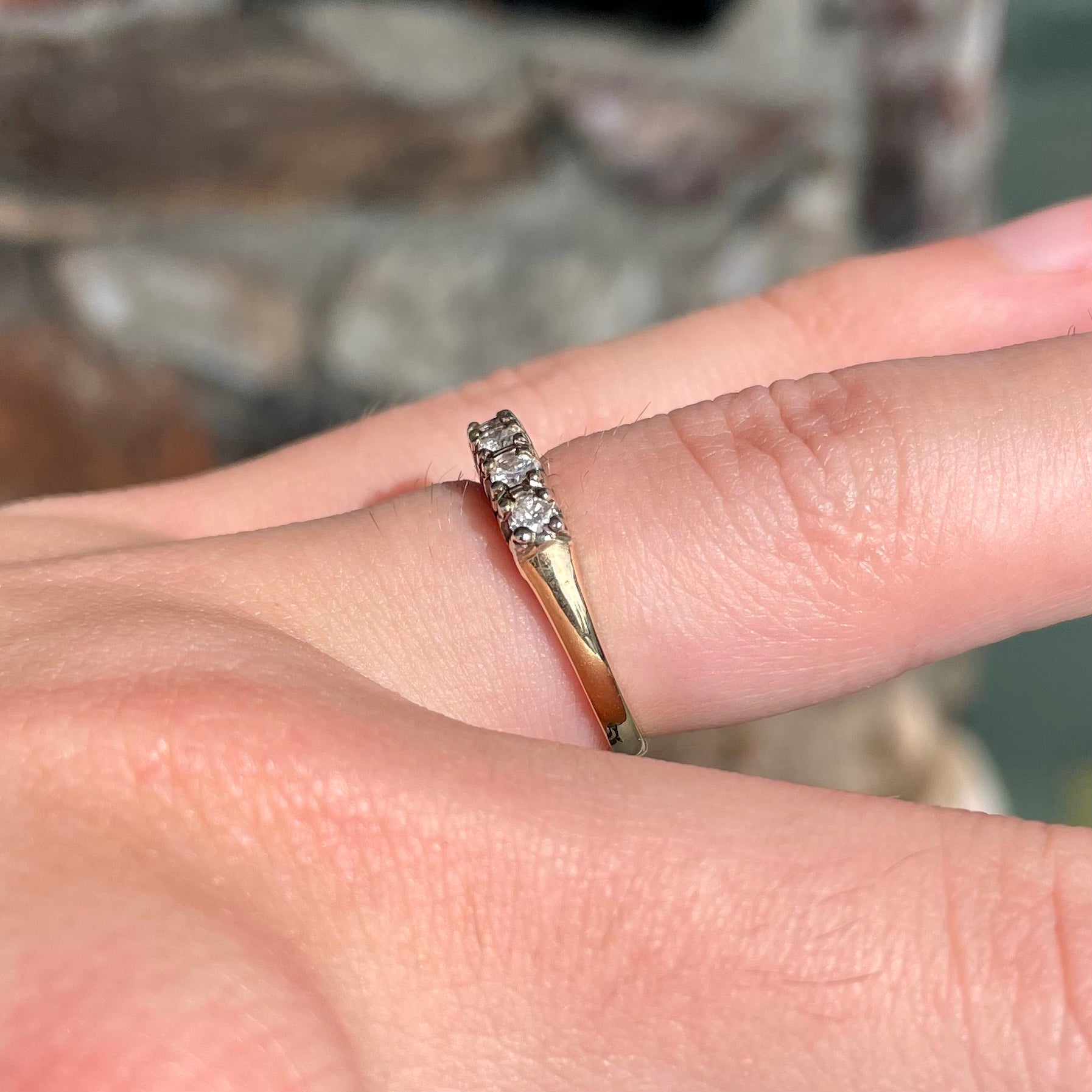 A vintage ladies' five-stone round cut diamond yellow gold wedding band