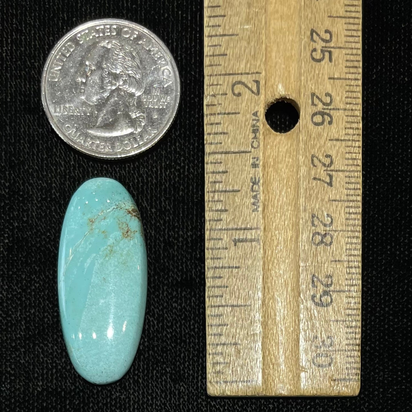 A loose, light blue, oval cabochon cut turquoise stone from Sleeping Beauty Mine, Arizona.