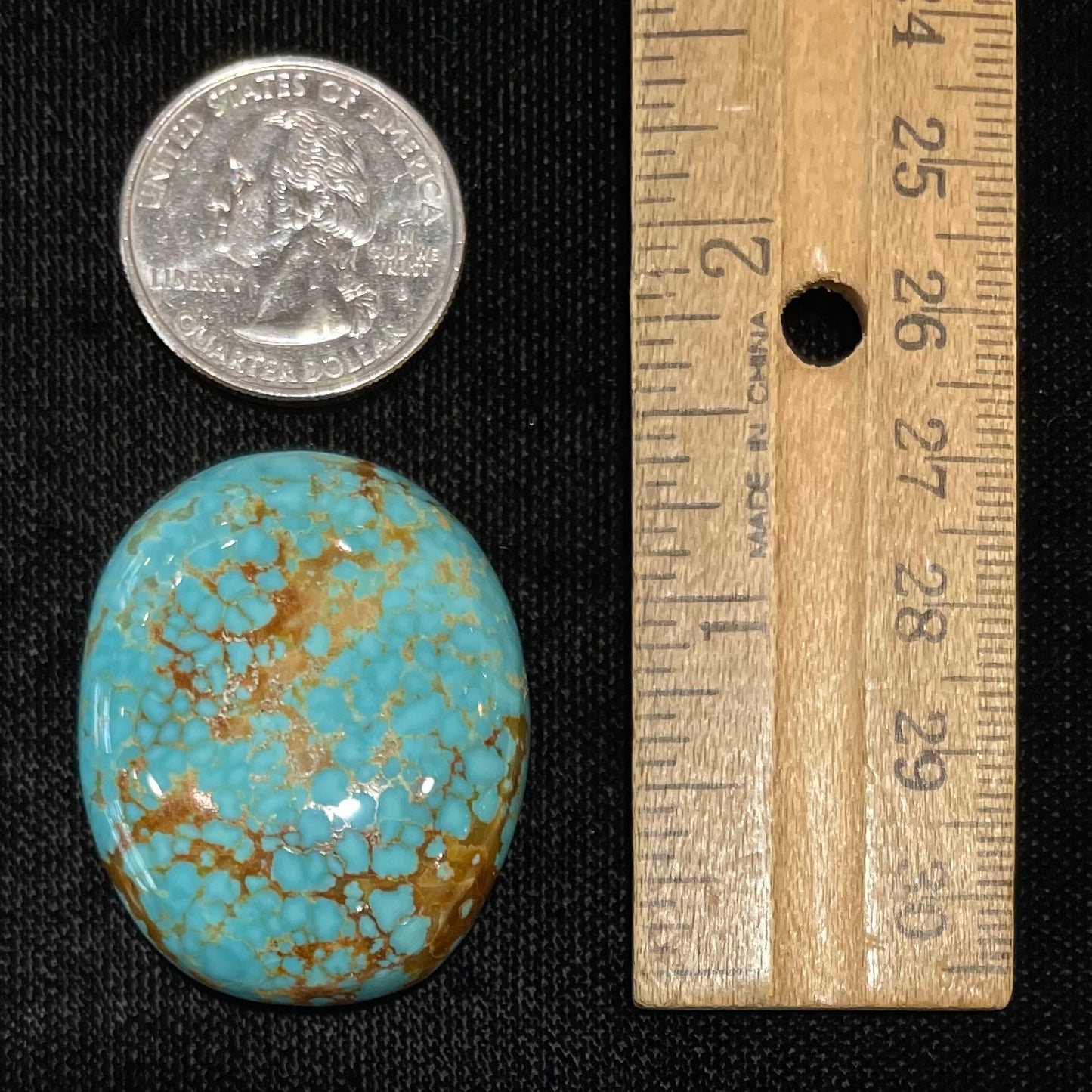 A loose, oval cut turquoise cabochon from Number 8 Mine, Nevada.  The stone is blue with a golden brown webbed matrix.