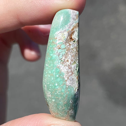 A loose, polished variscite stone from Utah, USA.
