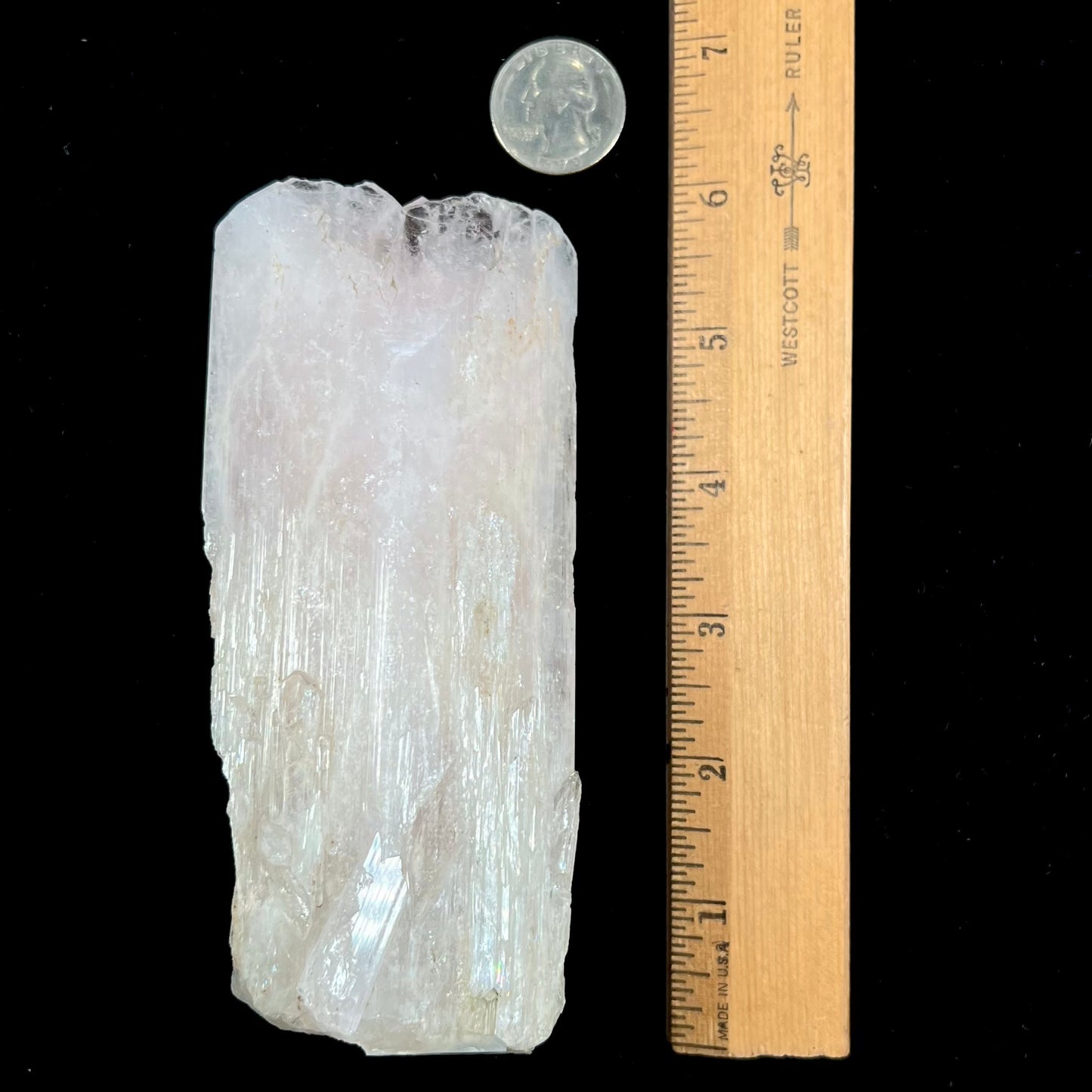 A 5.5 inch long pink danburite crystal that weighs over one pound.