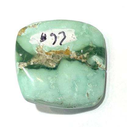 A loose, cushion cabochon cut variscite stone from Utah, USA.