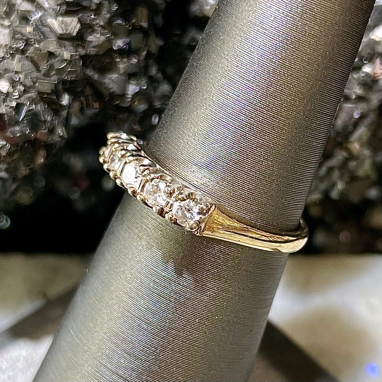 A vintage ladies' five-stone round cut diamond yellow gold wedding band