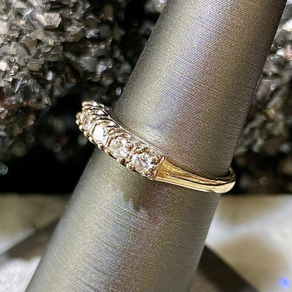 A vintage ladies' five-stone round cut diamond yellow gold wedding band