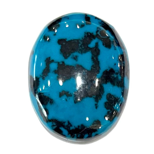 A loose, oval cabochon cut chrysocolla cabochon.