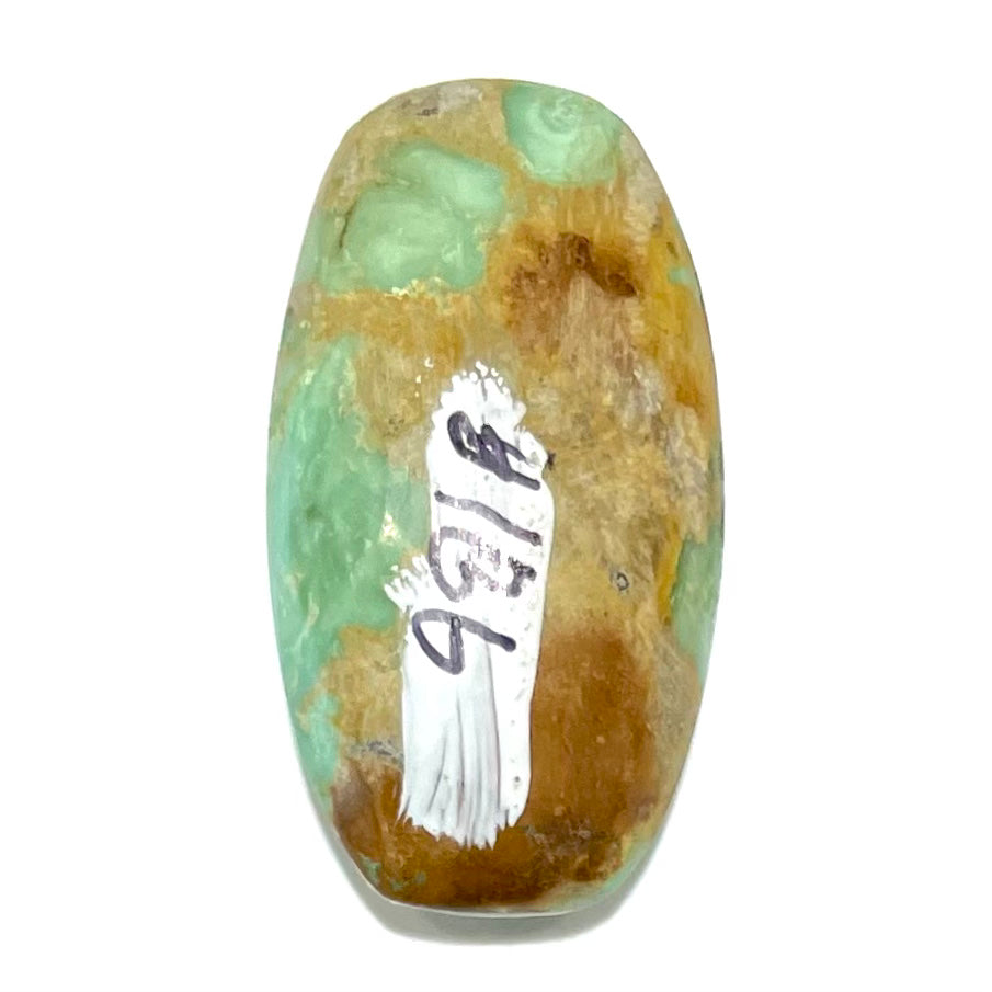 A loose, cabochon cut, green turquoise stone with brown matrix.