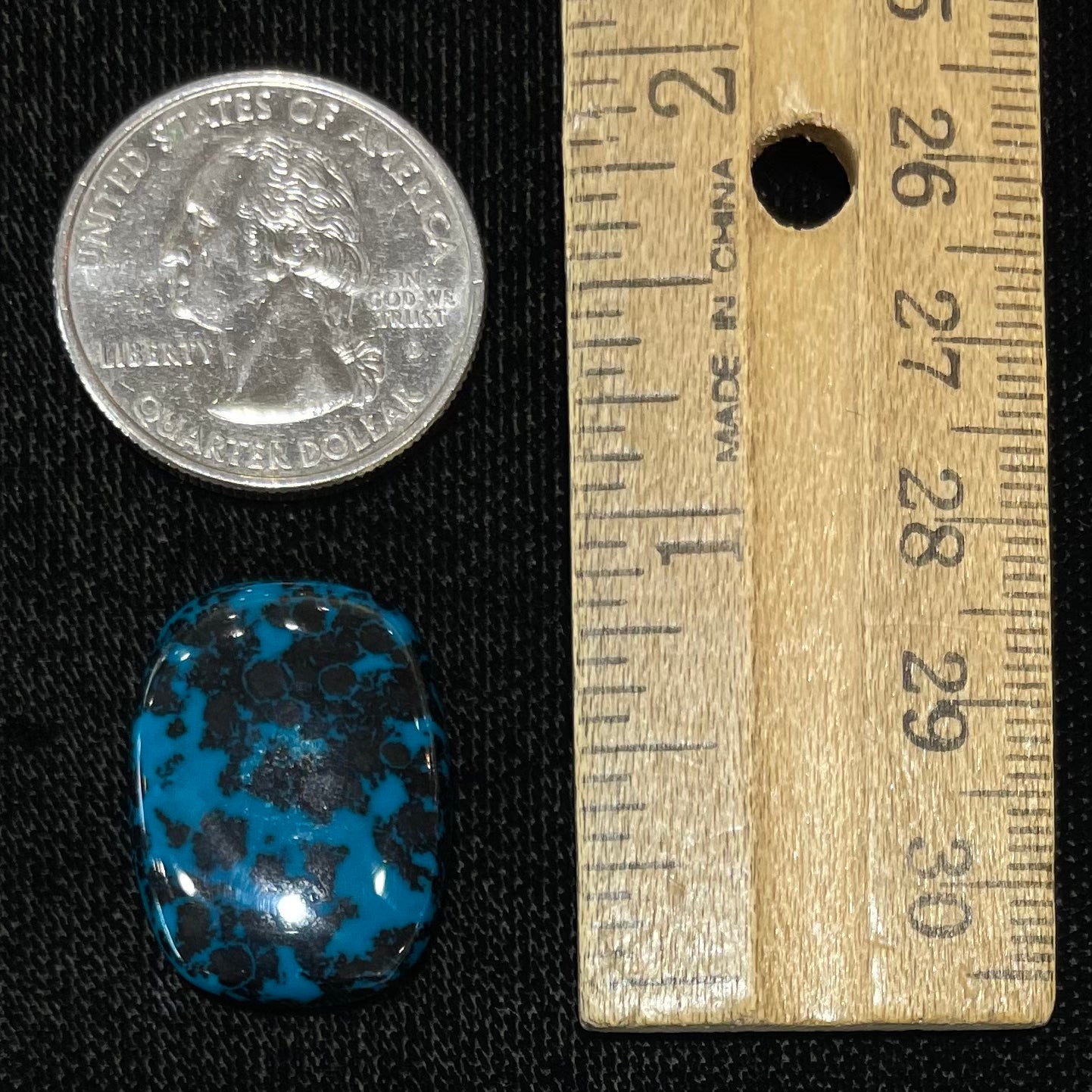 A loose, cushion cabochon cut chrysocolla stone.