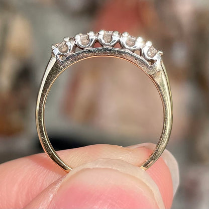 A vintage ladies' five-stone round cut diamond yellow gold wedding band