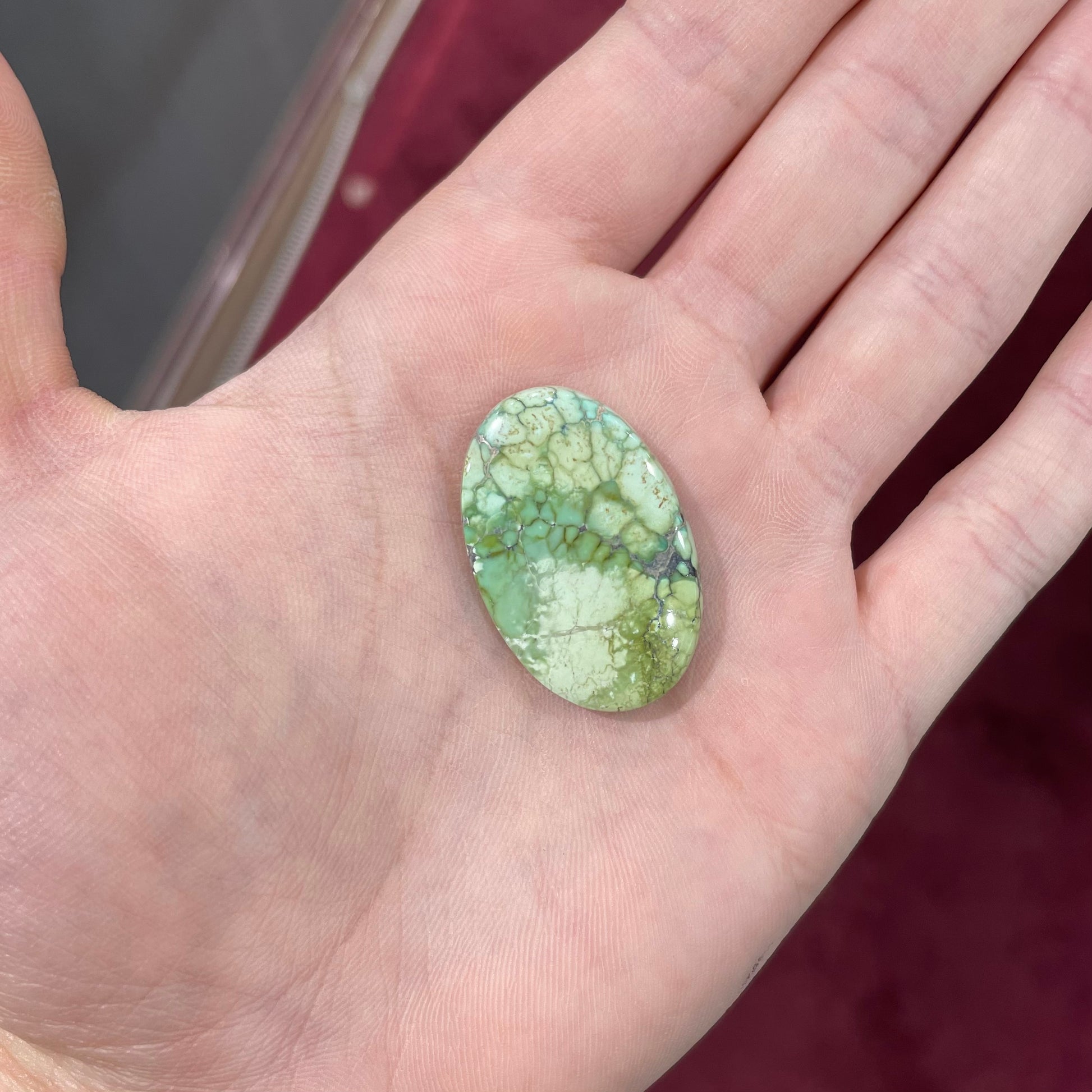 A loose, green turquoise stone cabochon from the Number 8 Mine.