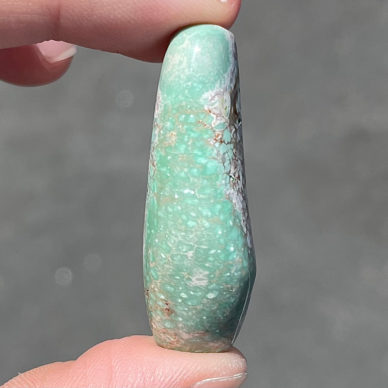 A loose, polished variscite stone from Utah, USA.