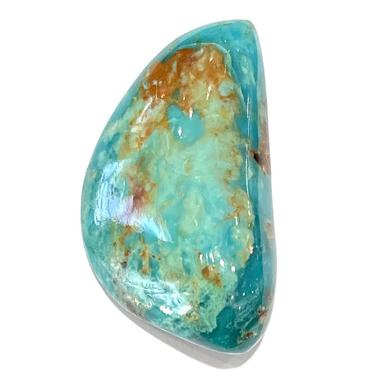 A loose freeform cut turquoise stone from the Royston Mining District in Nevada.