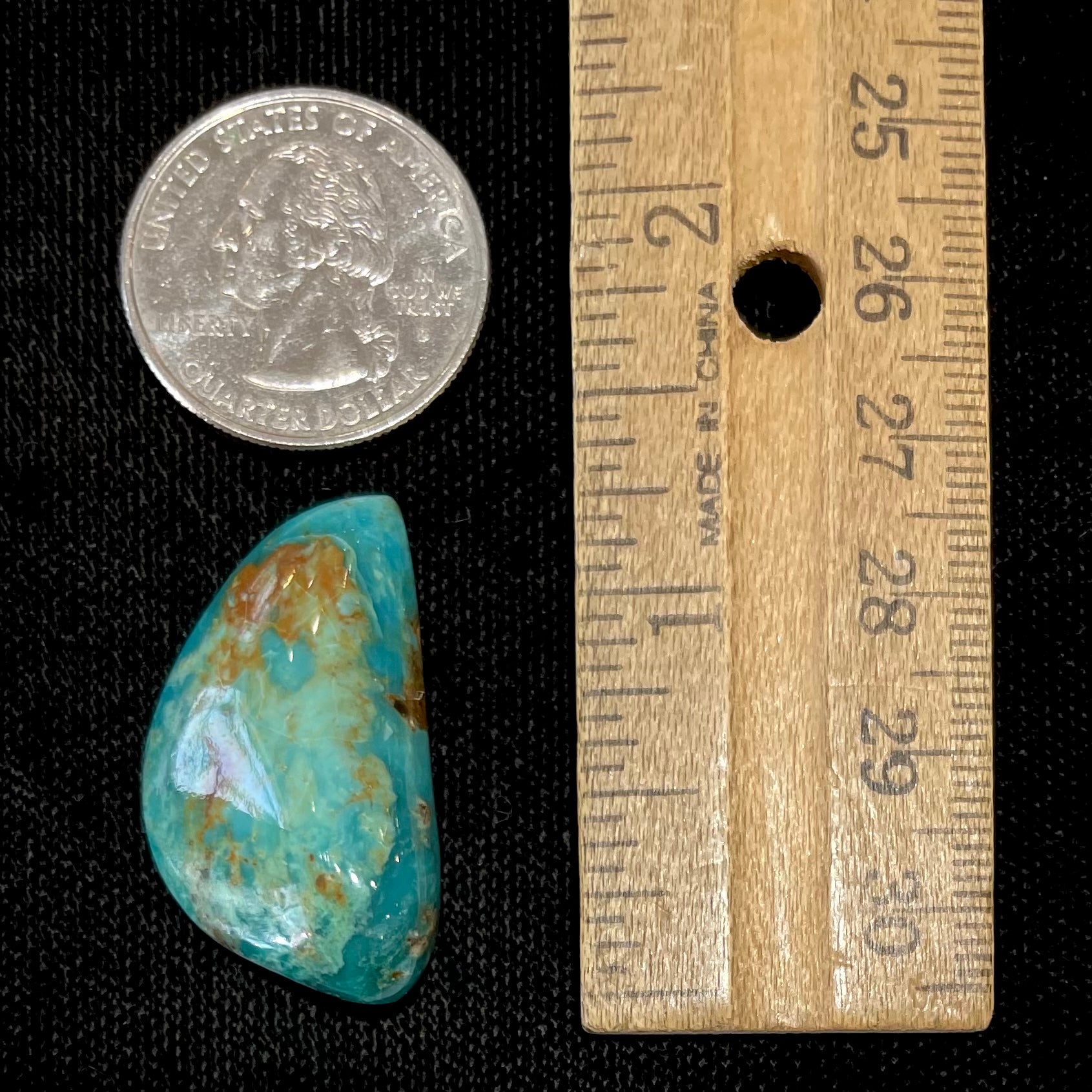 A loose freeform cut turquoise stone from the Royston Mining District in Nevada.