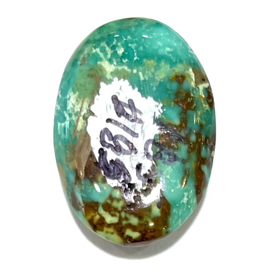 A loose, oval cabochon cut, green turquoise stone from Royston Mining District, Nevada.