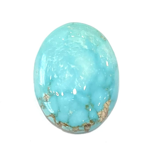 A loose, oval cabochon cut blue turquoise stone from Sonora, Mexico.