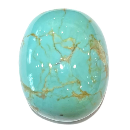 A loose turquoise stone cabochon from Royston Mining District, Nevada.  The stone has yellow matrix inclusions.