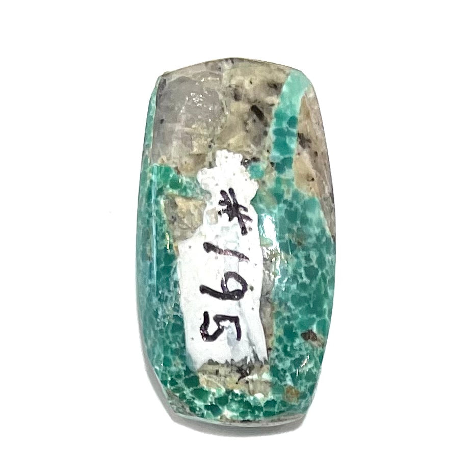 A loose, green cabochon cut turquoise stone from Royston District, Nevada.