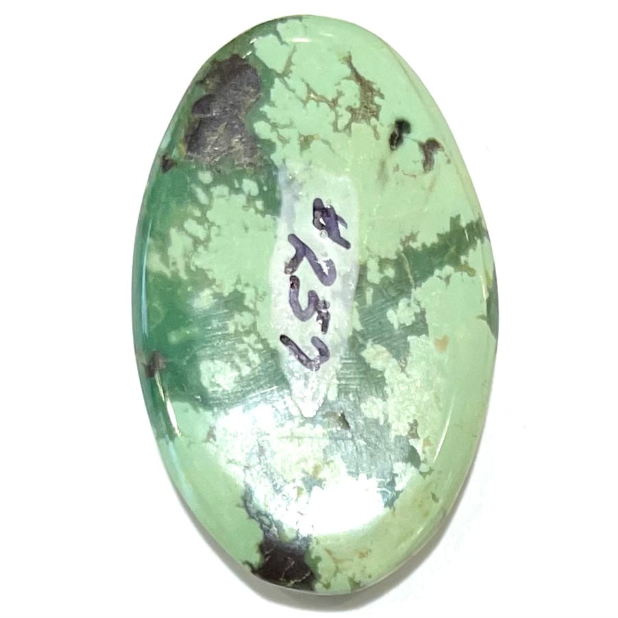 A loose, oval cabochon cut variscite stone from Utah, USA.