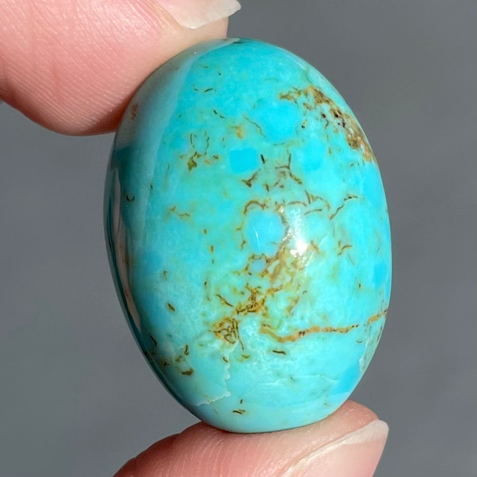 A loose Pilot Mountain turquoise stone cabochon.