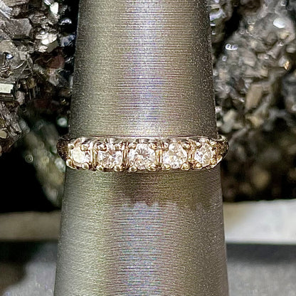 A vintage ladies' five-stone round cut diamond yellow gold wedding band