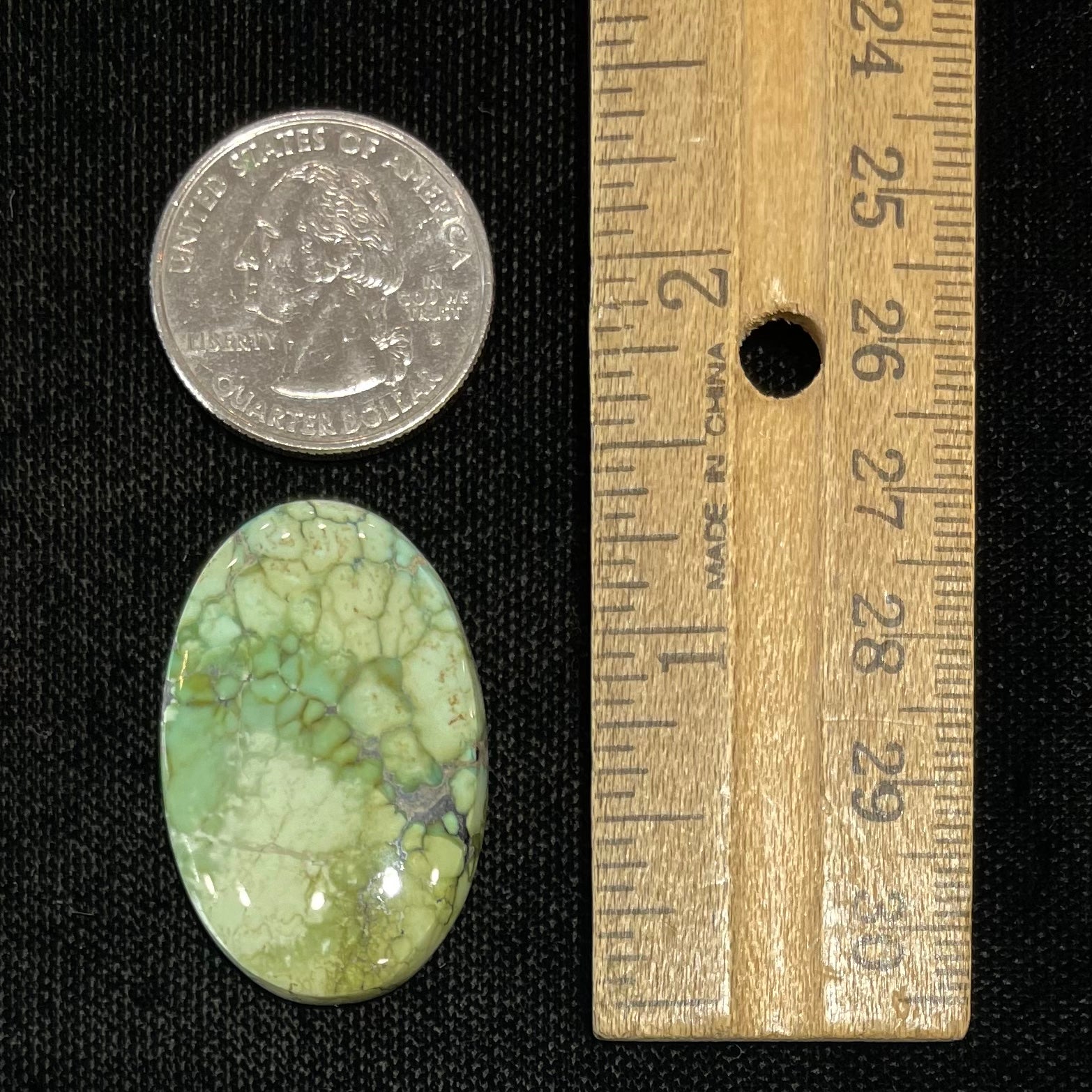 A loose, green turquoise stone cabochon from the Number 8 Mine.