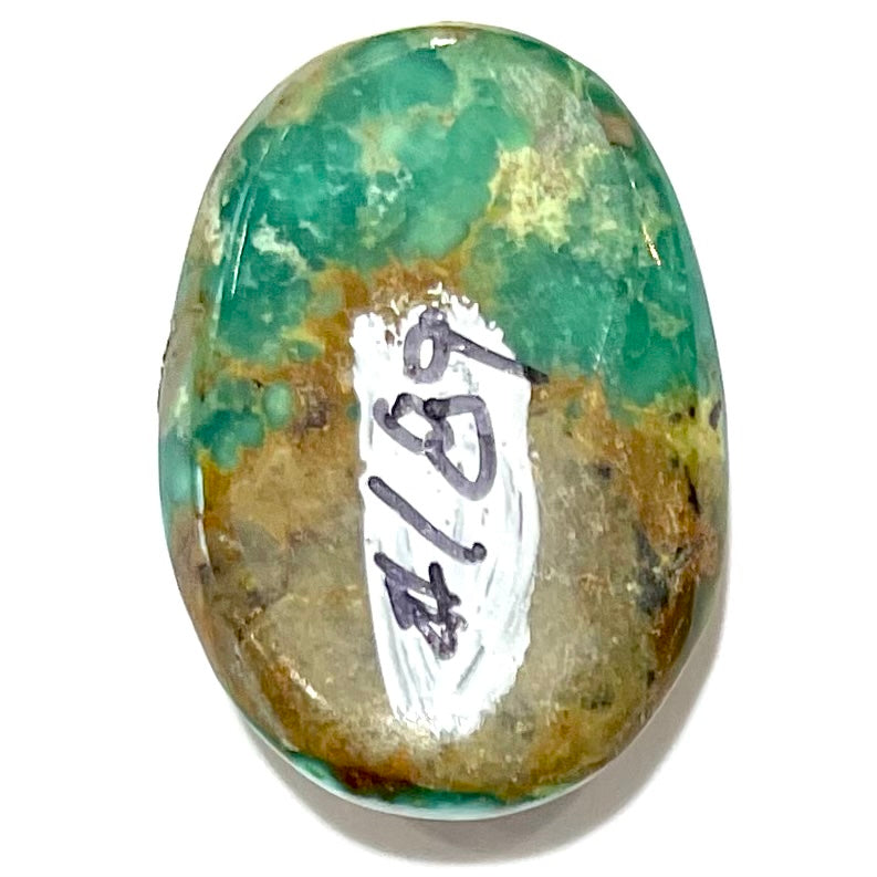 A loose, oval cabochon cut green and brown turquoise stone from Royston Mining District, Nevada.