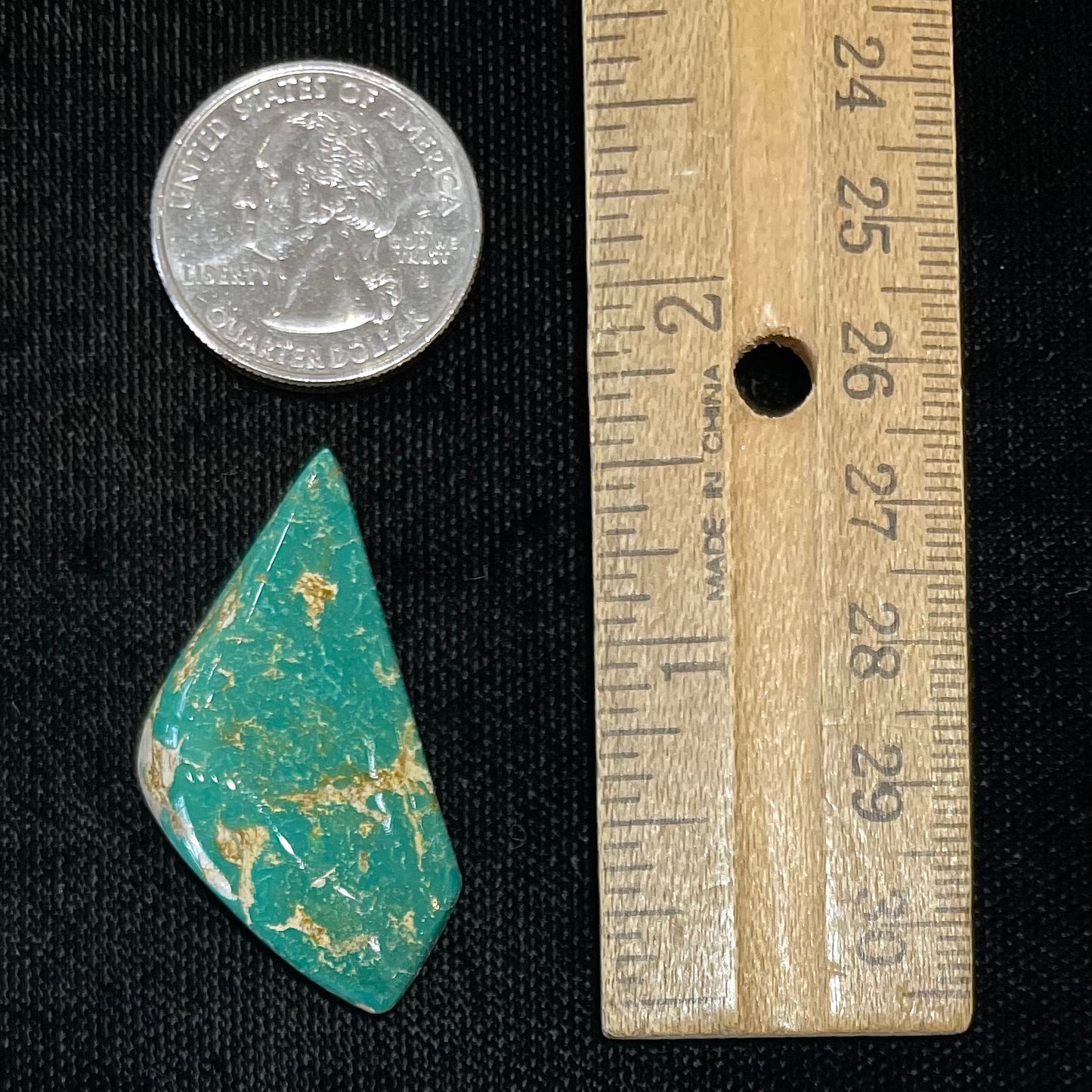 A loose, freeform cabochon cut green turquoise stone from Royston Mining District, Nevada.