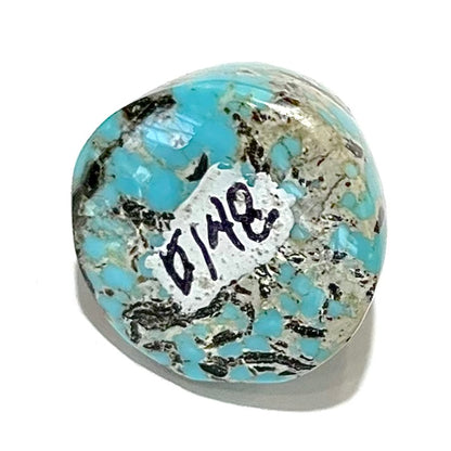 A loose, multicolored, round cabochon cut turquoise stone from Valley Blue Mine in Lander County, Nevada.