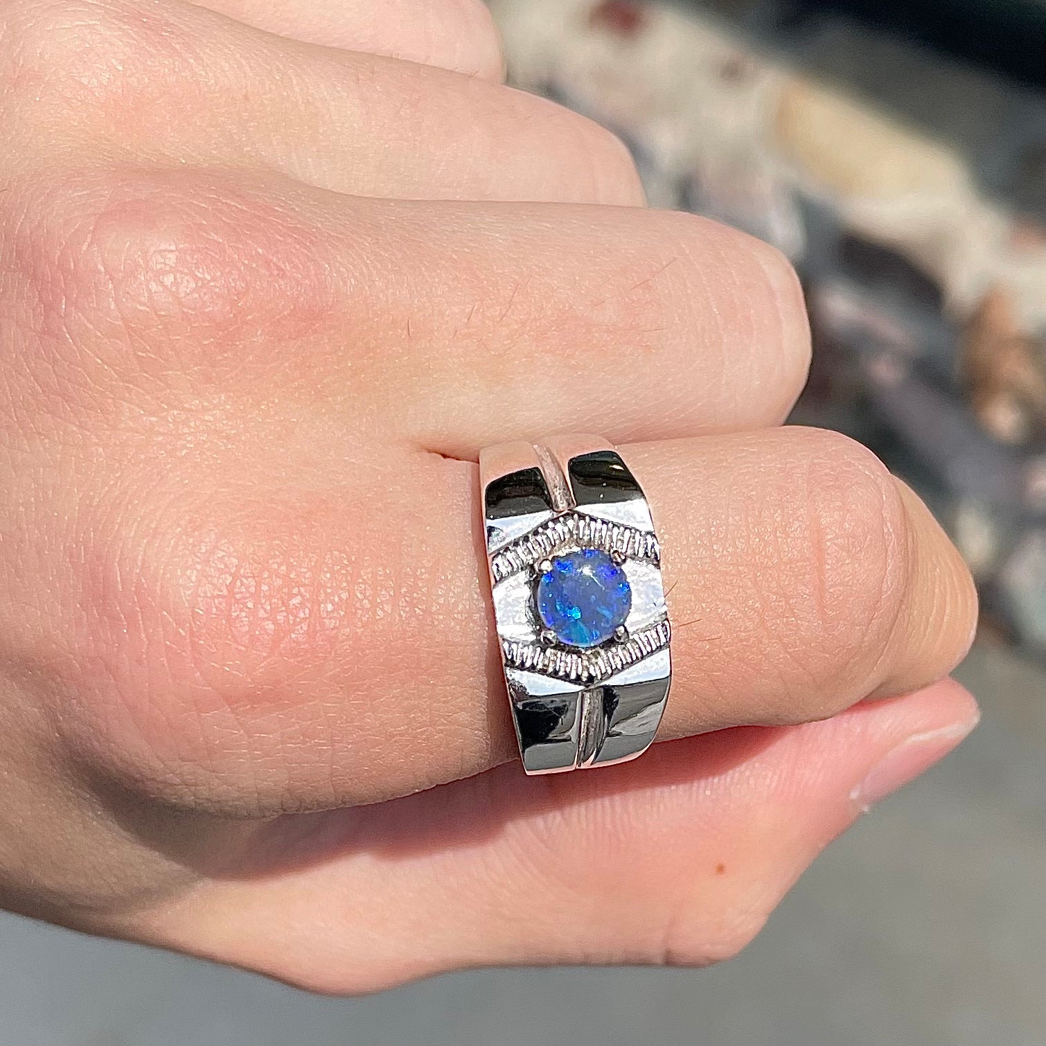 A round black crystal opal solitaire sterling silver men's ring.