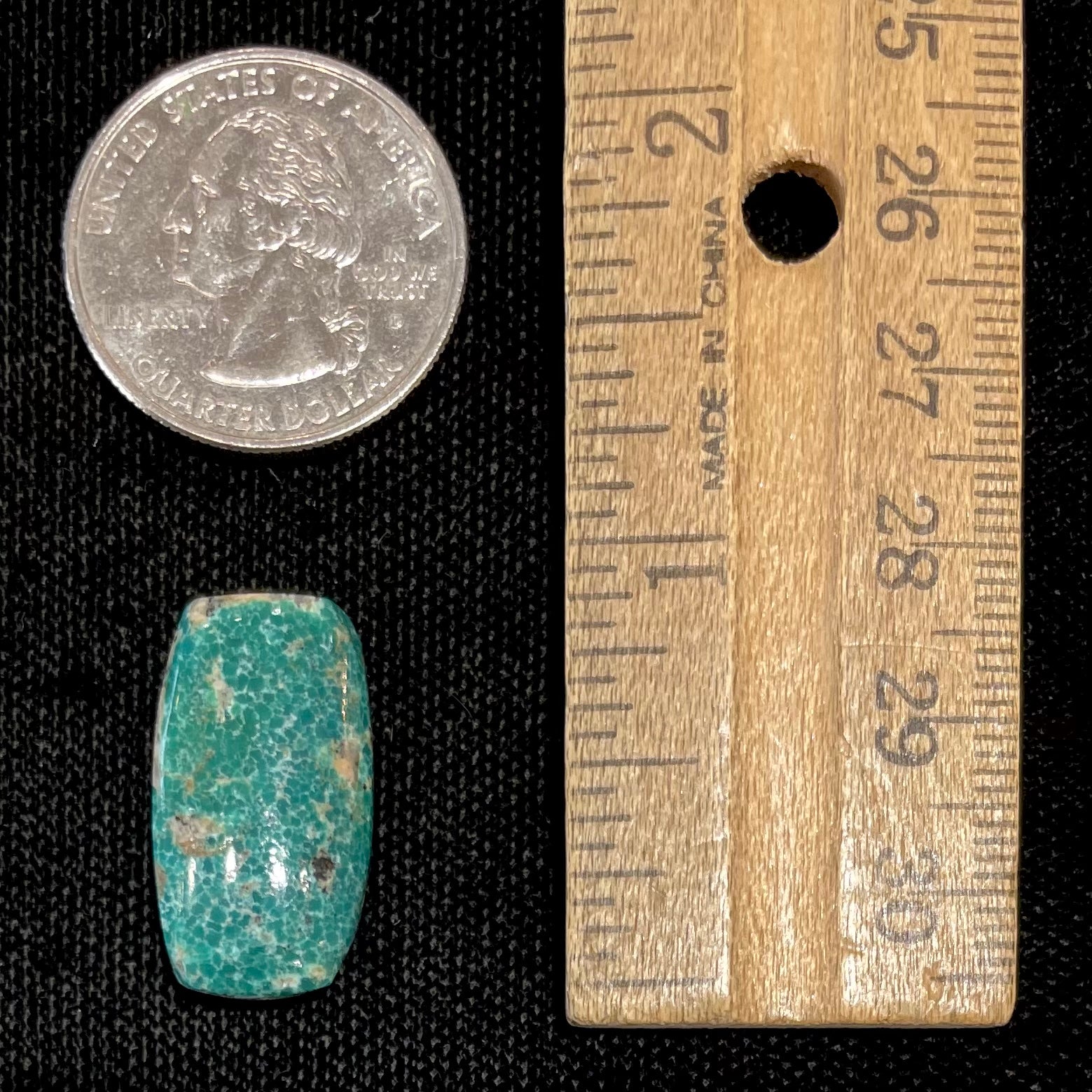 A loose, green cabochon cut turquoise stone from Royston District, Nevada.