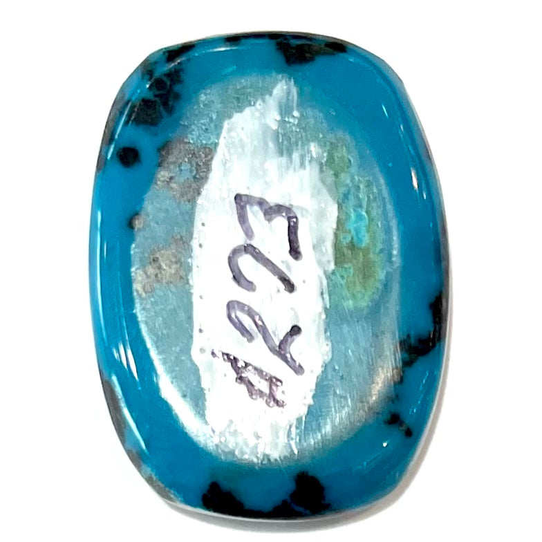 A loose, cushion cabochon cut chrysocolla stone.