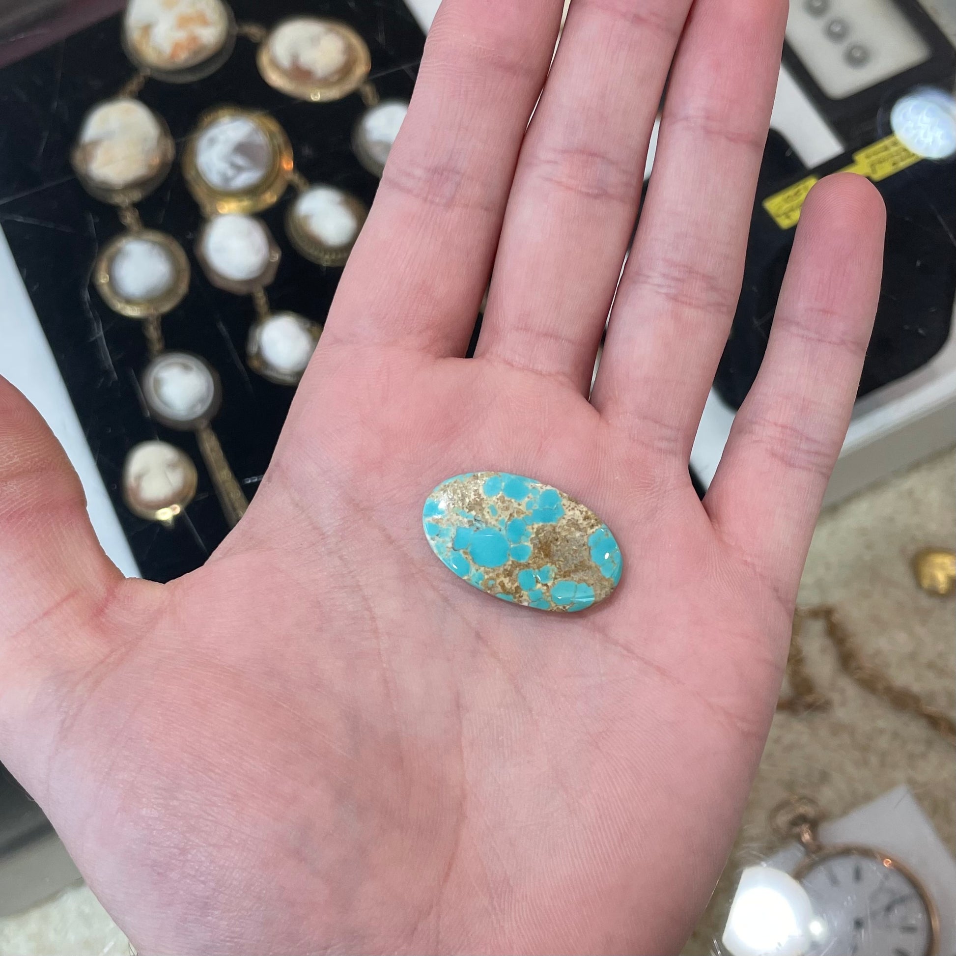 An oval cabochon cut loose Fox turquoise stone.