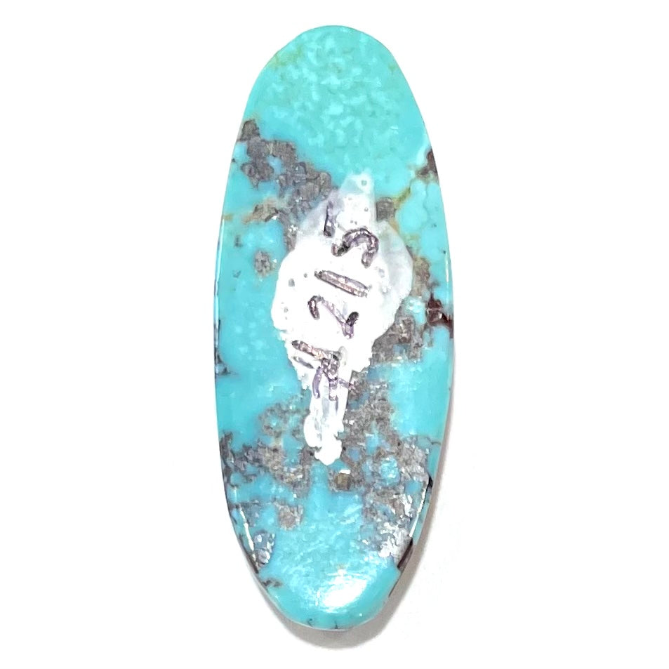 A loose, oval cabochon cut blue and red matrix turquoise stone from Royston District, Nevada.