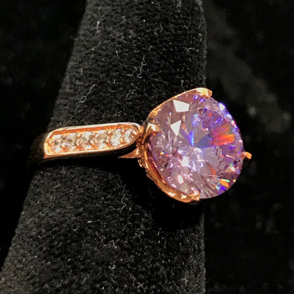 Purple Cubic Zirconia Ring with White Cubic Zirconia side stones. Rose Gold Plated over Sterling Silver.