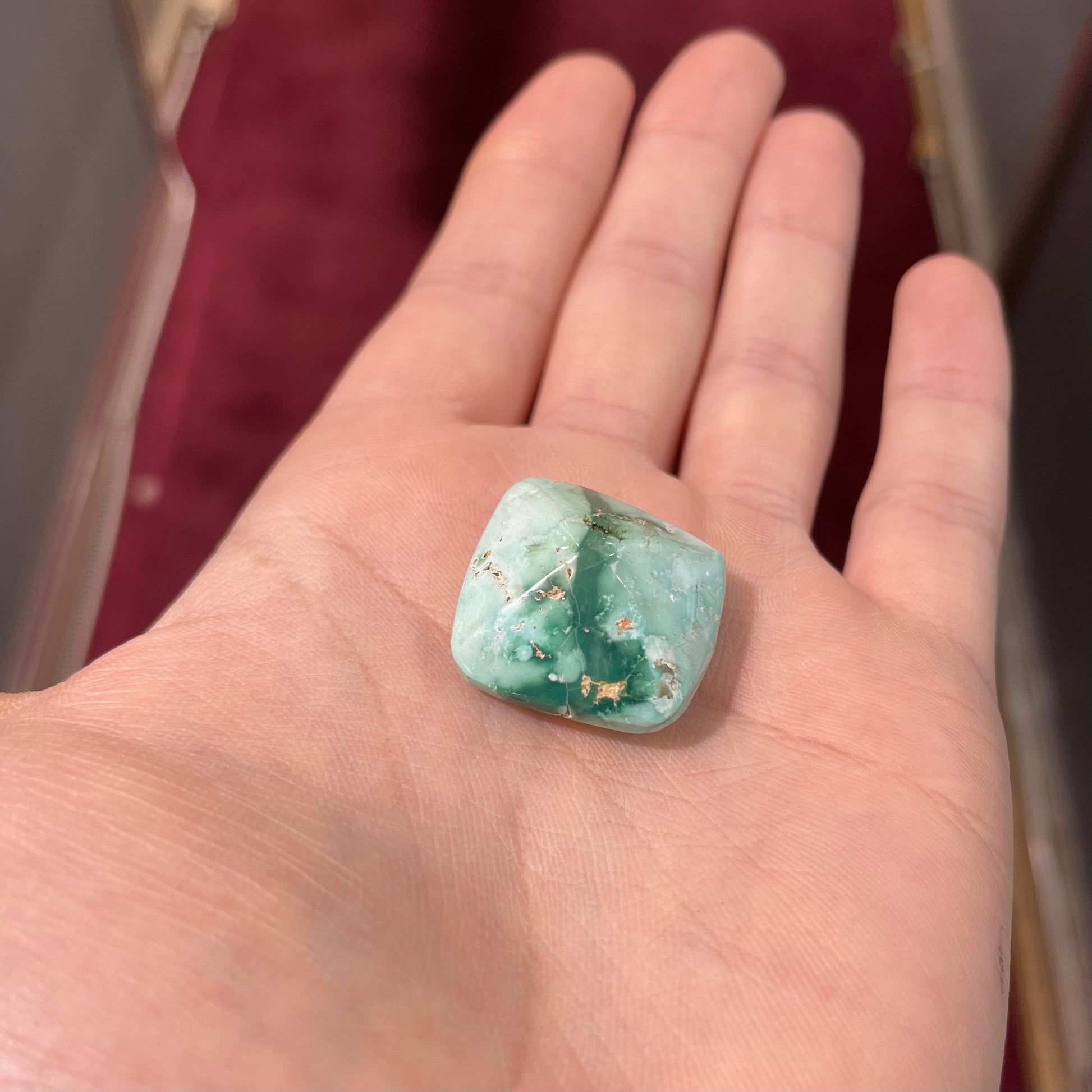 A loose, cushion cabochon cut variscite stone from Utah, USA.