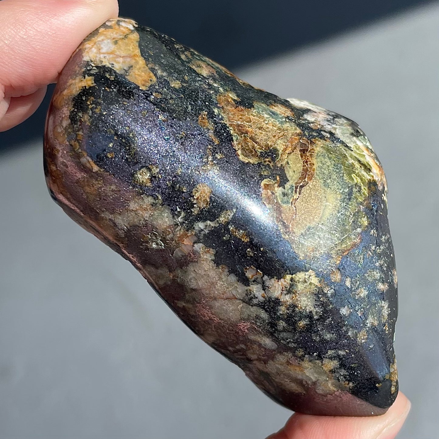 A polished copper specimen with pyrite inclusions.