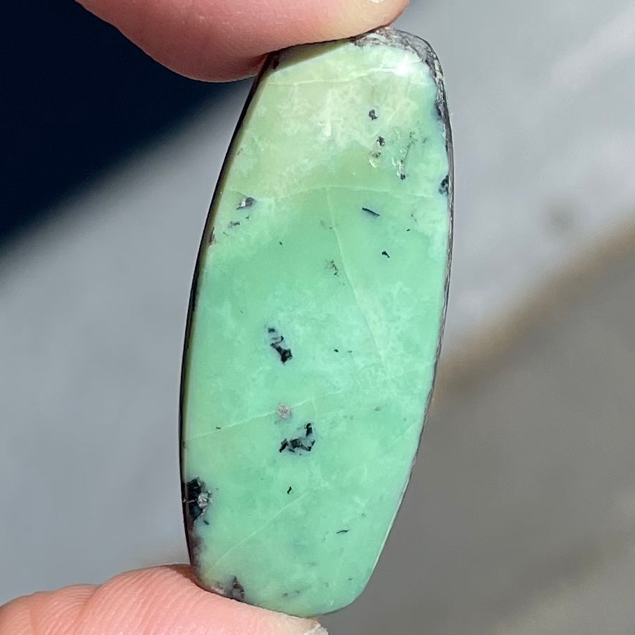 A loose, green turquoise stone cabochon from Royston Mining District, Arizona.