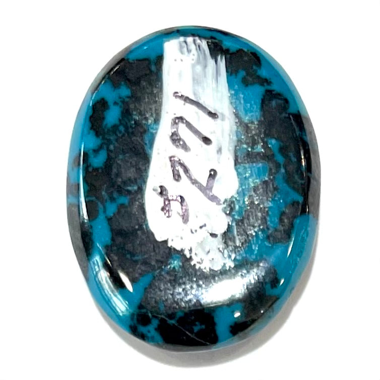A loose, oval cabochon cut chrysocolla cabochon.