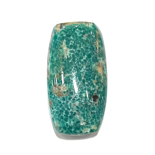 A loose, green cabochon cut turquoise stone from Royston District, Nevada.