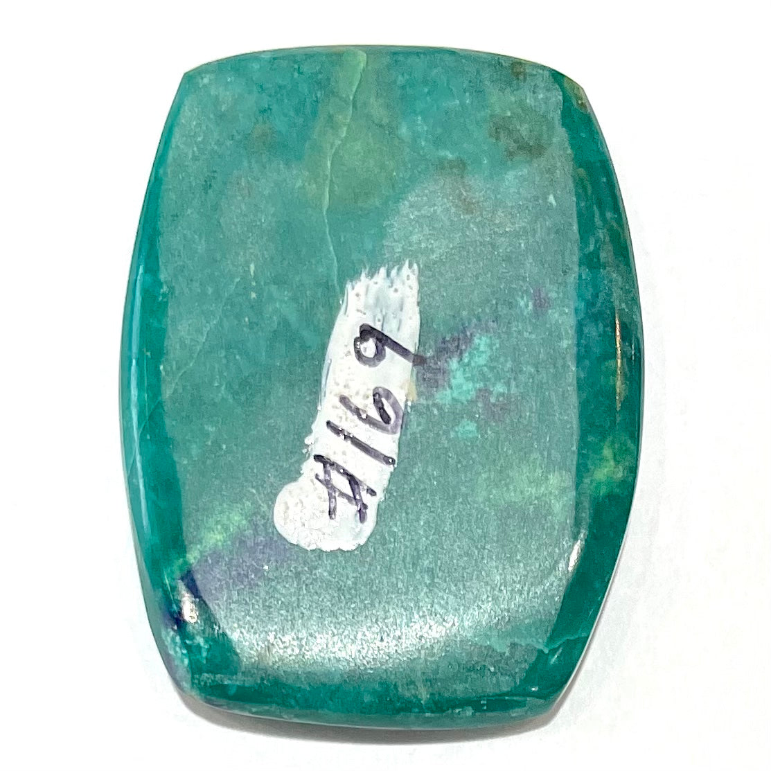 A polished, cushion shaped chrysocolla stone with azurite inclusions.
