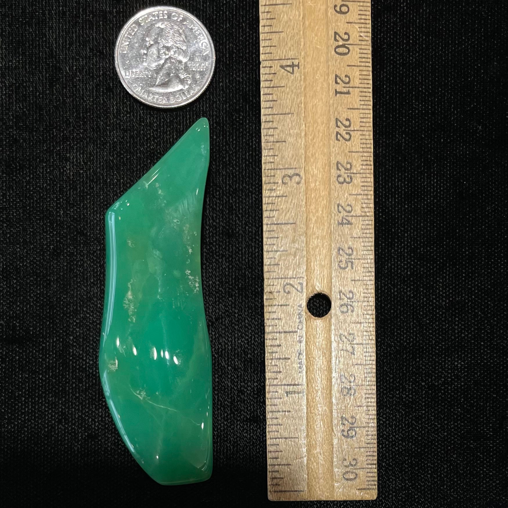 A polished, freeform shape chrysocolla specimen that measures 3.3 inches by 1 inch.