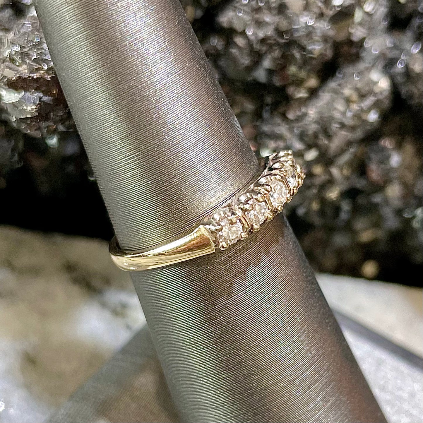 A vintage ladies' five-stone round cut diamond yellow gold wedding band