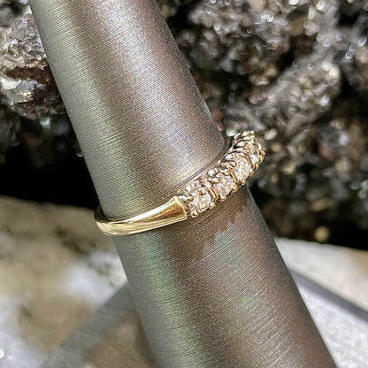 A vintage ladies' five-stone round cut diamond yellow gold wedding band