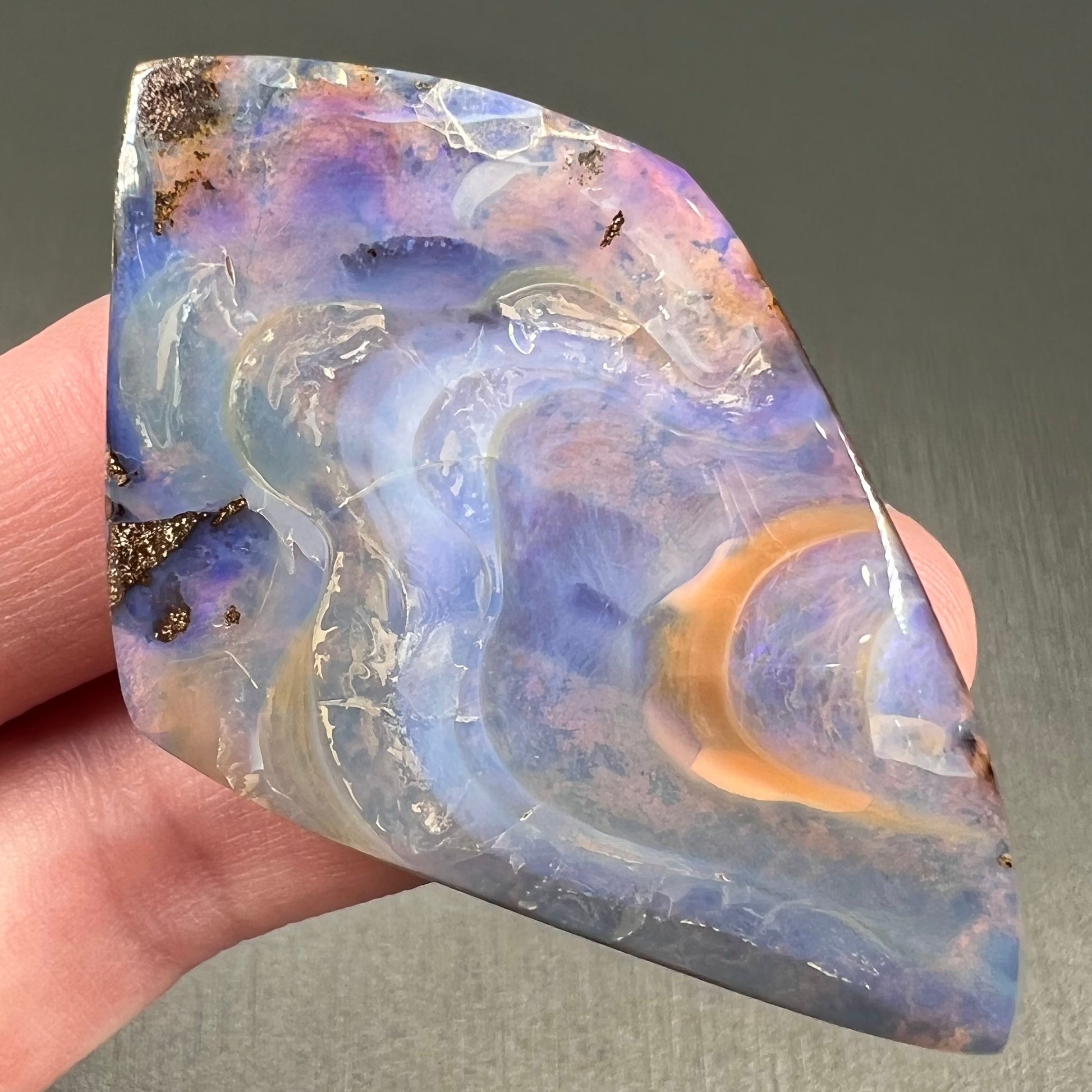 A polished, purple Quilpie boulder opal stone from Queensland, Australia.