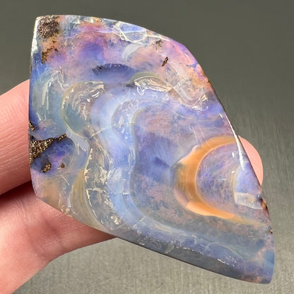 A polished, purple Quilpie boulder opal stone from Queensland, Australia.