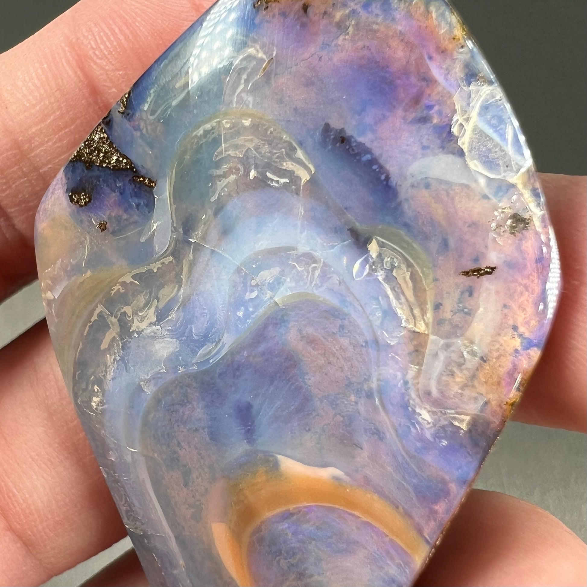 A polished, purple Quilpie boulder opal stone from Queensland, Australia.